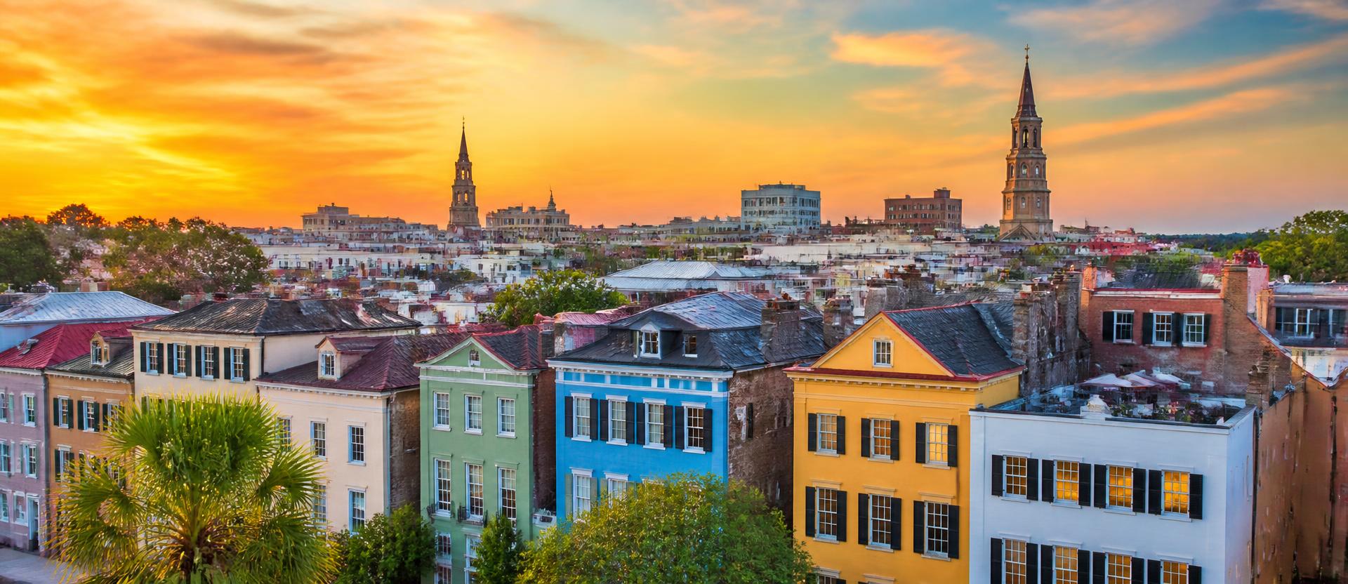 Colourful row houses under a vivid sunset sky