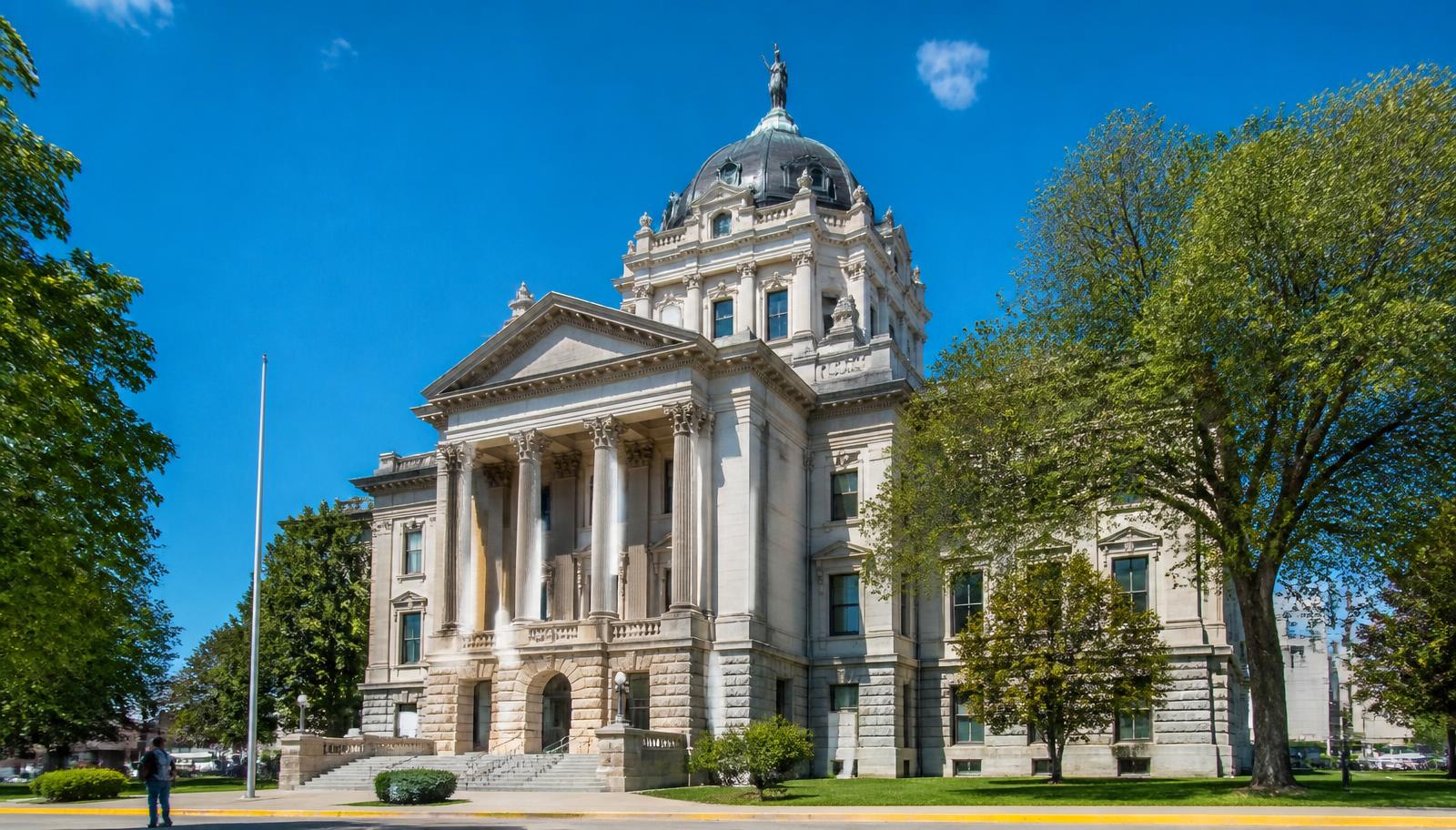 County courthouse with columns under a blue sky