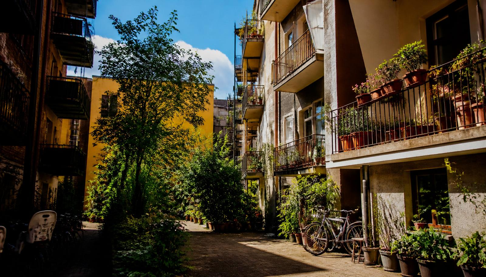 Sunlit apartment courtyard with balconies and plants