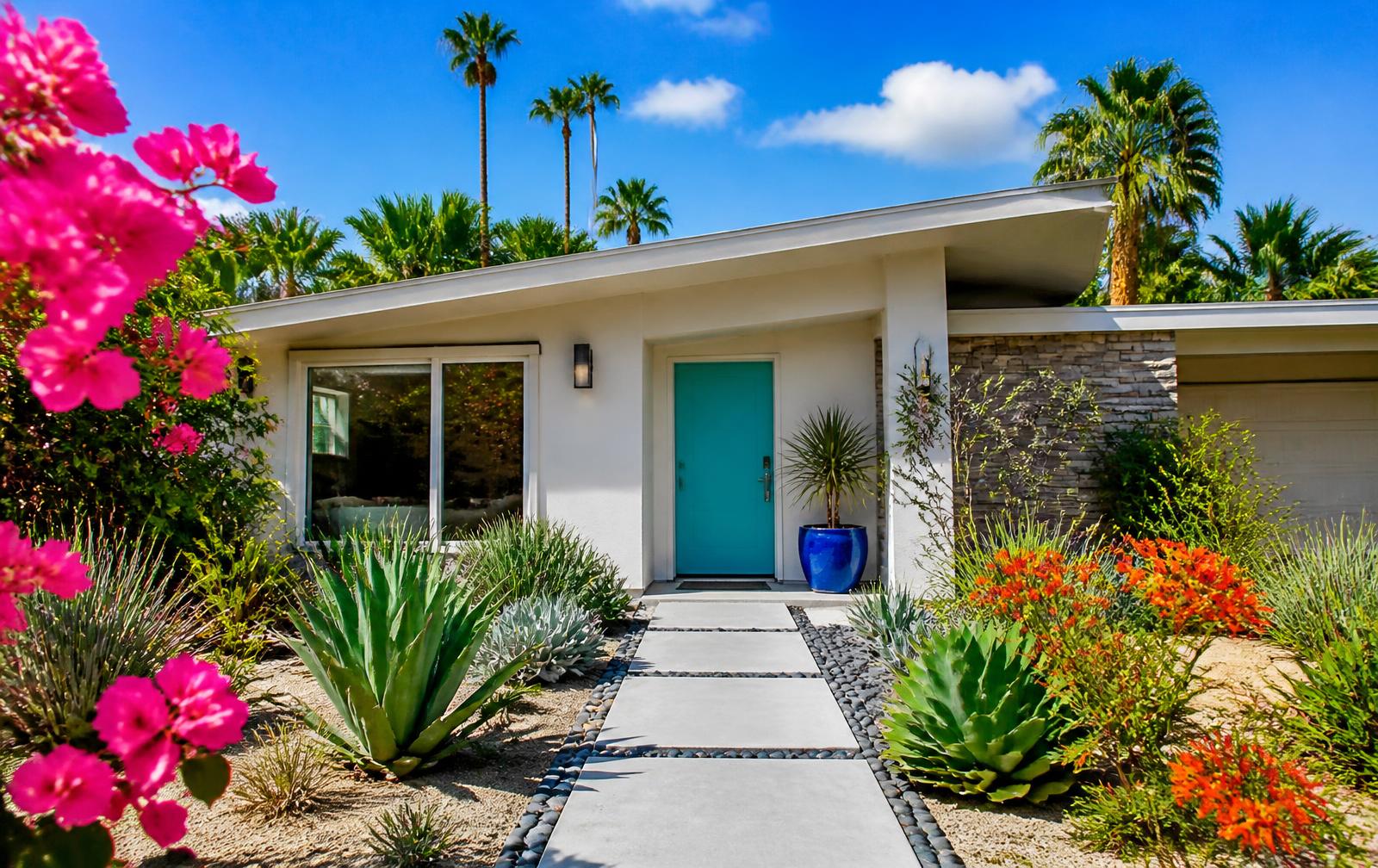 Colourful mid-century home with a turquoise front door in full sun